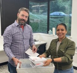 Two employees of Texan Registered Agent sort through mail in the company's Austin, Texas office.