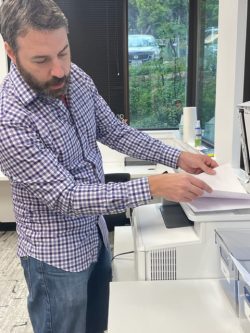 An employee of Texan Registered Agent copies documents at the office in Austin, Texas.