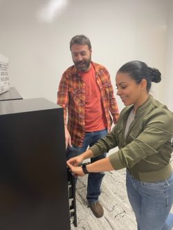 Two employees of Texan Registered Agent LLC at a filing cabinet in the Austin office.